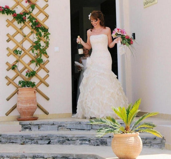 Julie Kelly leaves Villa Lindos Kalliopi on her way to marry William McMaster in Rhodes town.