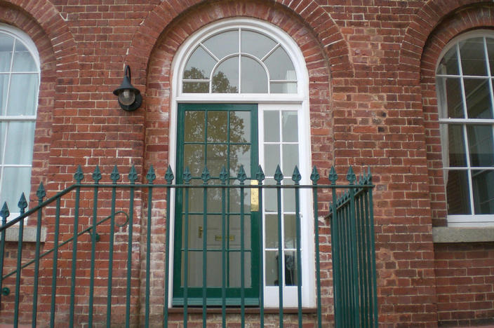 Glass panelled door with sidelights and circular head