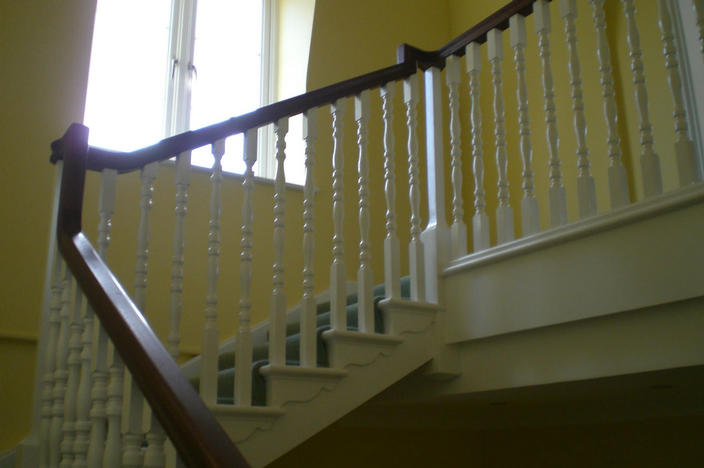 Staircase with cut strings and a sapele handrail