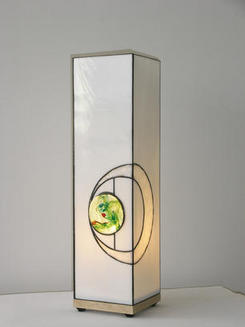Light on ash base with green glass stone set in white circle
