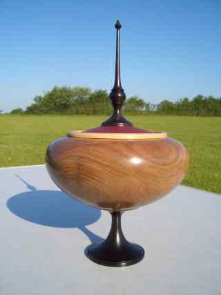 Elm rn with leather inlay to lid, African lackwood finial & pedistal