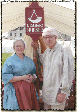 Erwin Tschanz and his wife Julie dressed in 18th century clothing outside their tent at Fort Niagara