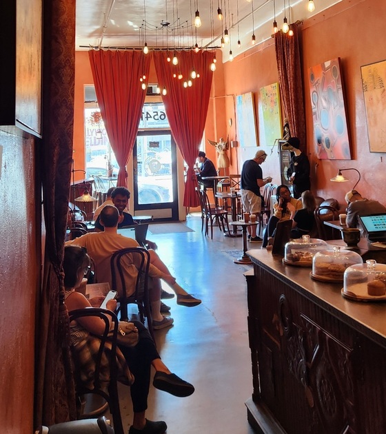 Afternoon at the coffee shop. Patrons relaxing and drinking coffee. 