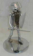 A miniature sculpture of a man with a metal detector