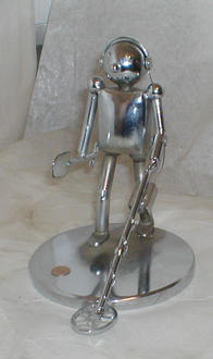 A miniature sculpture of a man with a metal detector