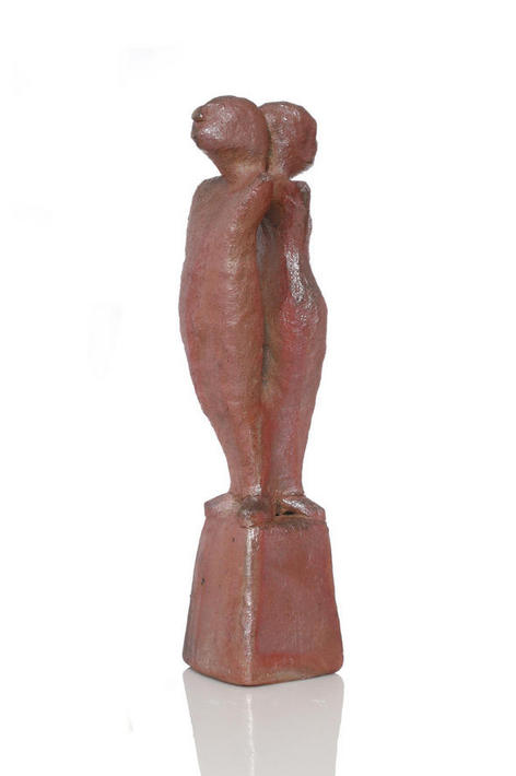 Two back to back figures balanced on a small pedestal not entirely happy with their situation