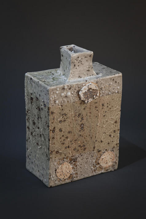 Bottle form with iron oxide speckles, raised surface and wadding additions