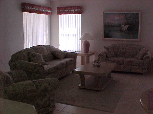 LIVING ROOM  (SLIDING GLASS DOORS ALLOW ENTRANCE TO POOL/PATIO AREA)