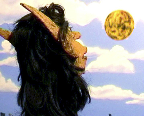 Corn Elf  Looking Up  At  A Ball Of Fire Flying Over Tree City