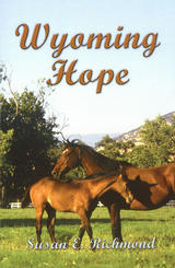 A picture of the book's cover which states the title Wyoming Hope and the author's name Susan E. Richmond.  The picture shows two horses in a grazing meadow with mountains on the horizon.