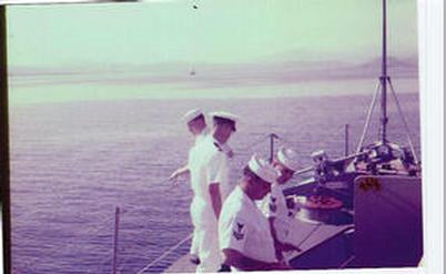 Unknown sailor,Ensign Glenn and unknown BM2, Bannister, BM1, slide was reversed when print was made