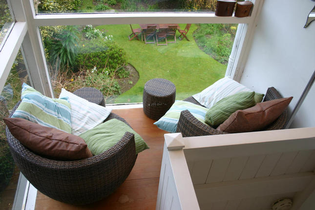 The comfortable seating area, which overlooks the garden and has views of the harbour and Island