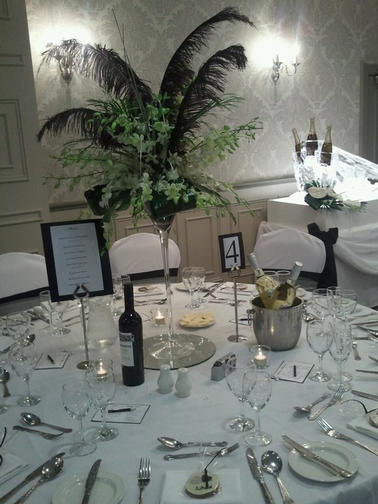 Martini Glasses Filled with Ostrich feathers and Singpore Orchids