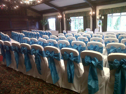 White chair covers with dark turquiose taffeta sashes