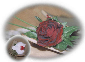a rose buttonhole (insert is a pahalanopsis orchid buttonhole)