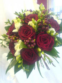 red rose, ivory freesia and winter berries posy